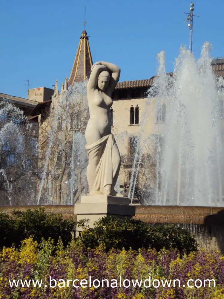 Youth - Statue by Josep Clarà set between flowers and a fountain