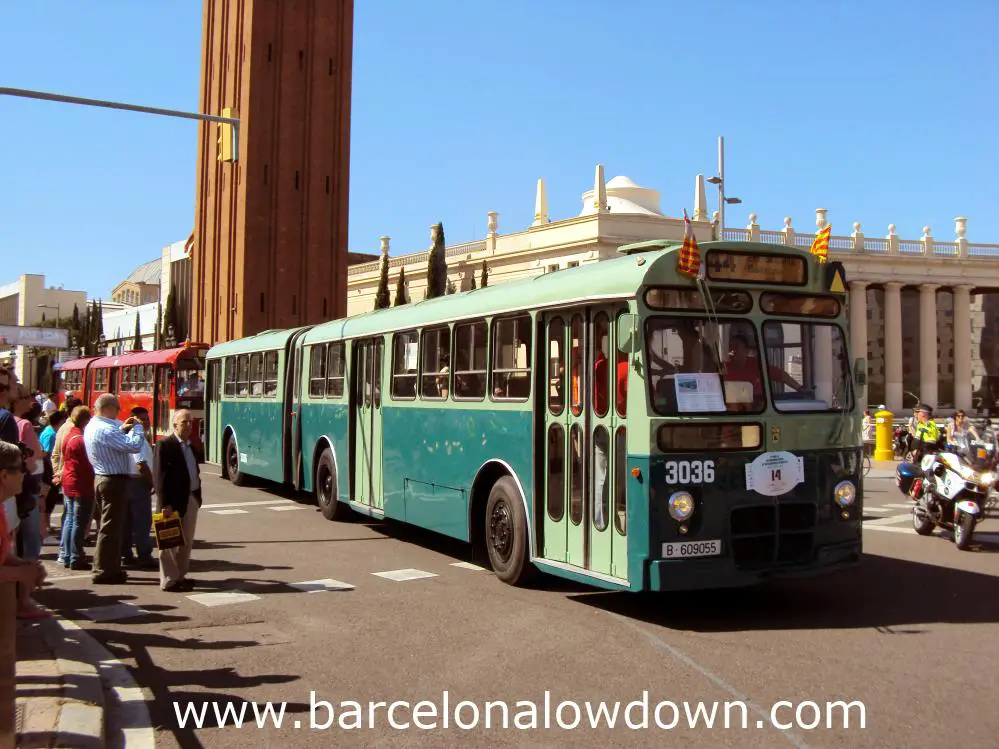 A green articulated bus in Barcelona