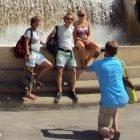 Tourists taking photos in front of a fountain near the MNAC Barcelona