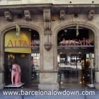 Photo of the Altaïr travellers bookshop barcelona on Gran Via with a masked pink elephant in the foreground