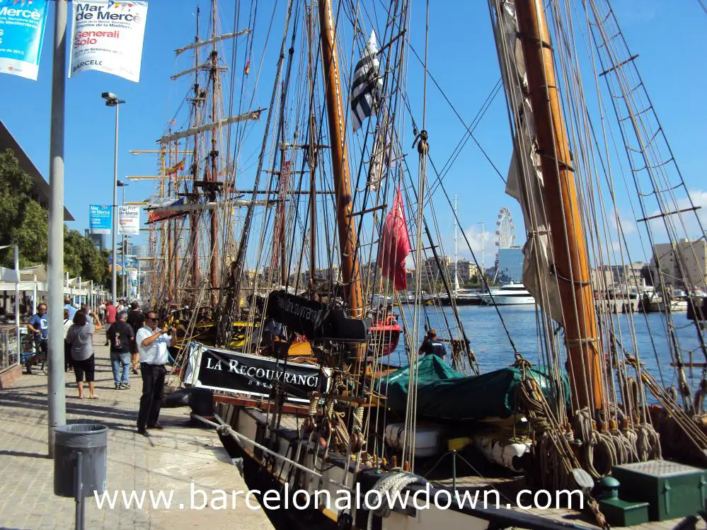A row of tall ships moored up in Barcelona's Port Vell