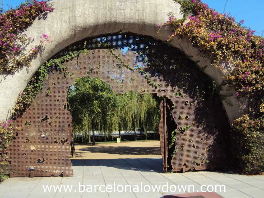 Iron gateway framed by purple flowers, Poblenou Barcelona
