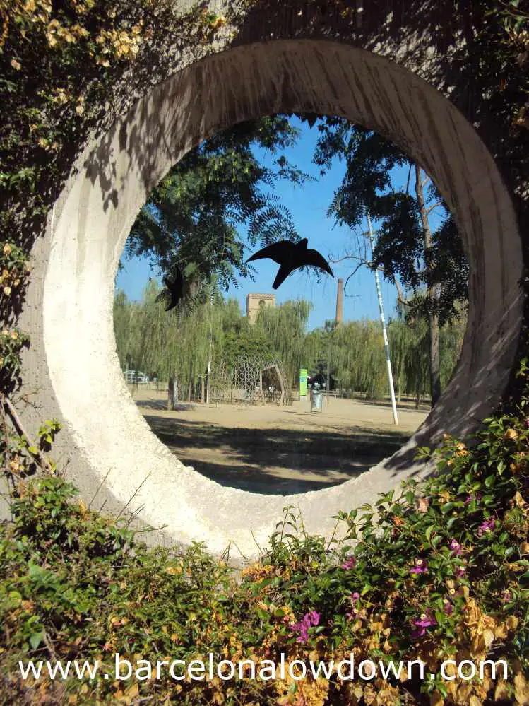 Photo of Poblenou's Central Park taken through one of the portholes in the perimeter wall