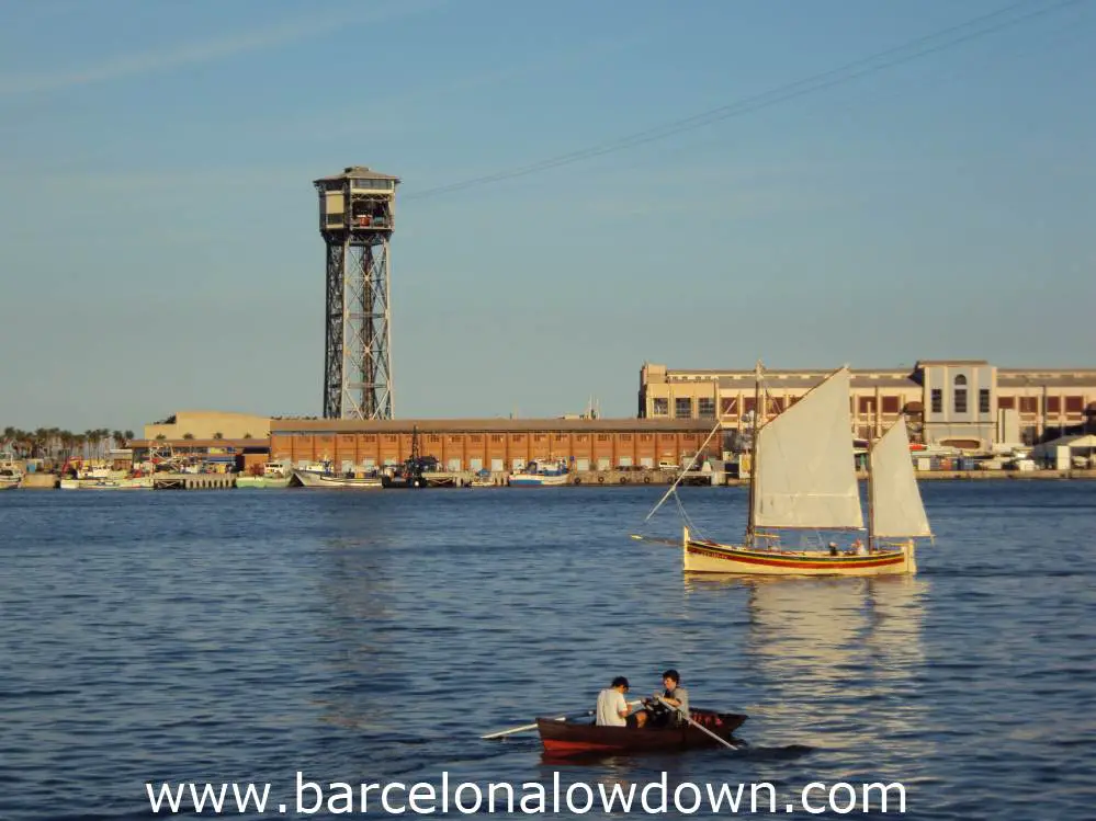 A sailing boat and a rowing boat in Barcelona's port