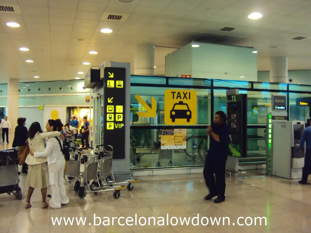 Signs at the top of the ramp down to the taxi rank at Barcelona airport