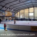 Adults and children skating at the BarGelona Christmas Ice Rink on Plaça de Catalunya in Central Barcelona