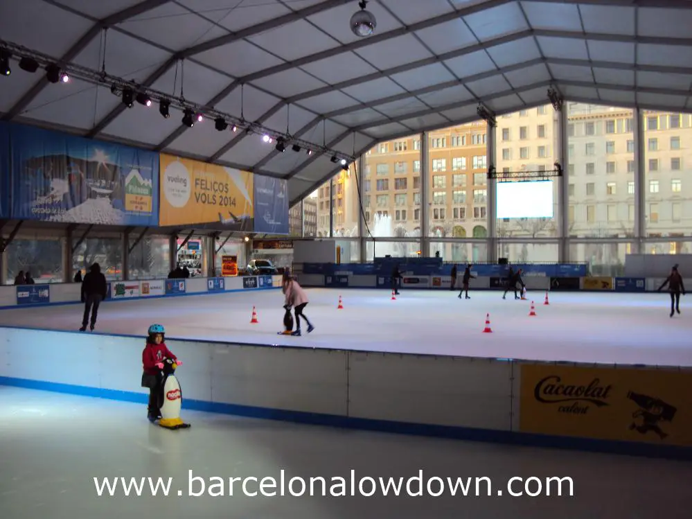 Adults and children skating at the BarGelona Christmas Ice Rink on Plaça de Catalunya in Central Barcelona