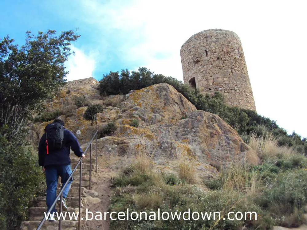 A walker hiking up hill to Burriac castle