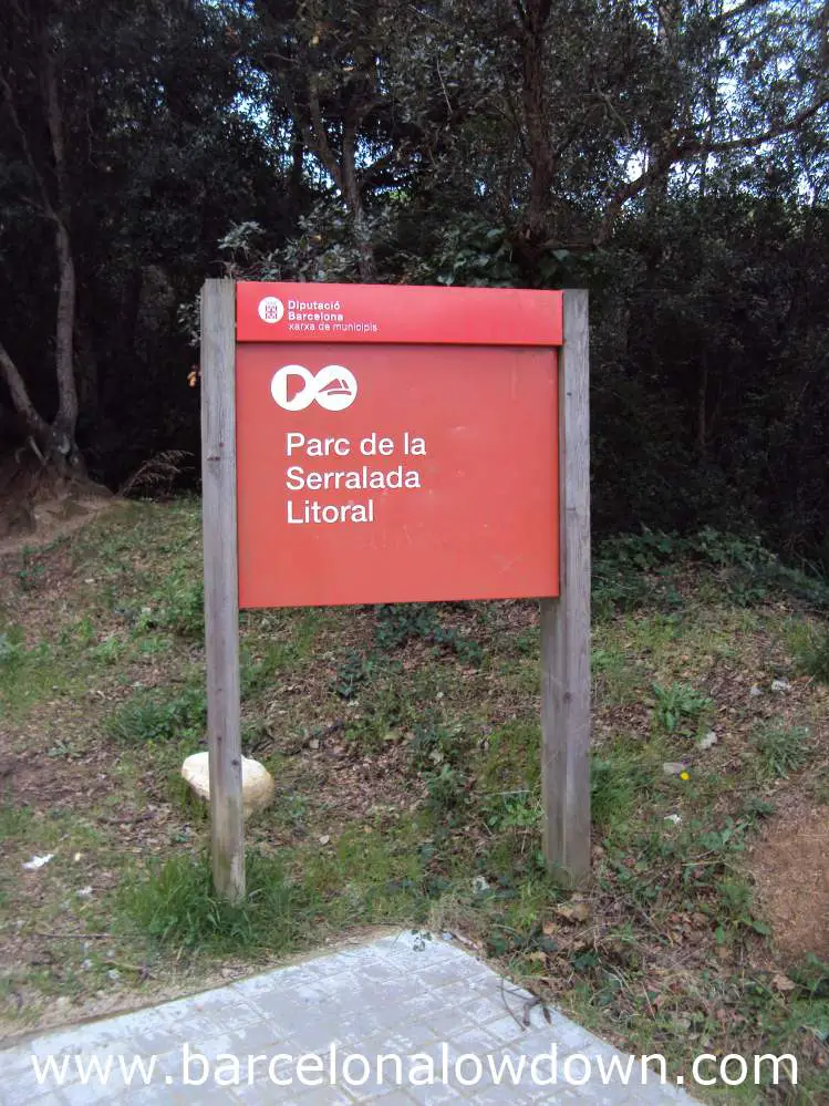 A red signpost at the start of the path leading to Burriac castle near Barcelona