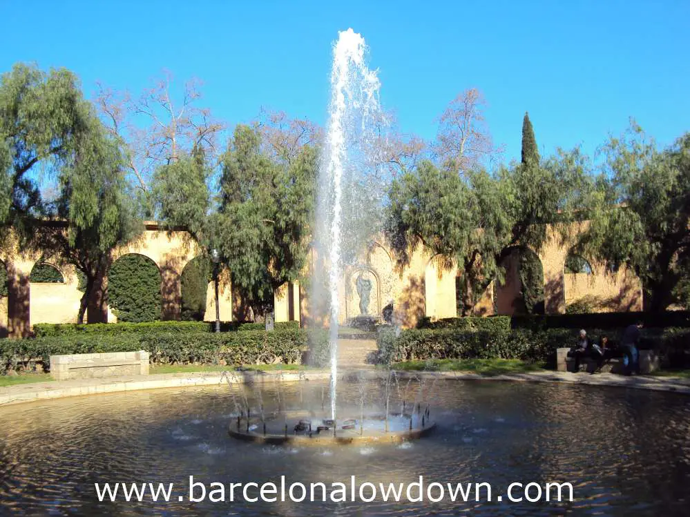 A decorative fountain surrounded by trees in one of the parks on Montjuic hill Barcelona