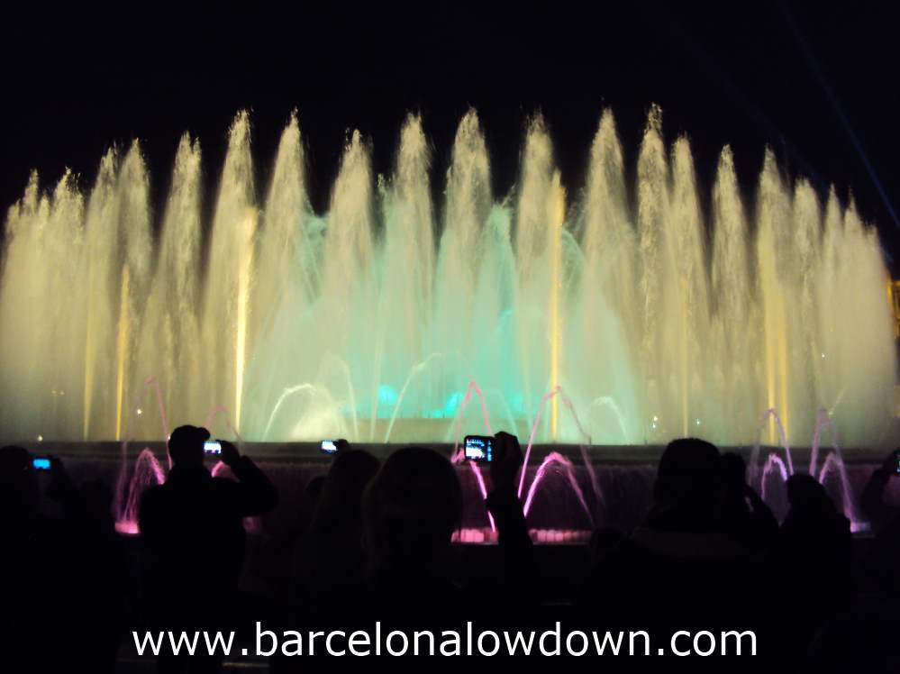 Tourists filming the Magic fountain with their mobile phones