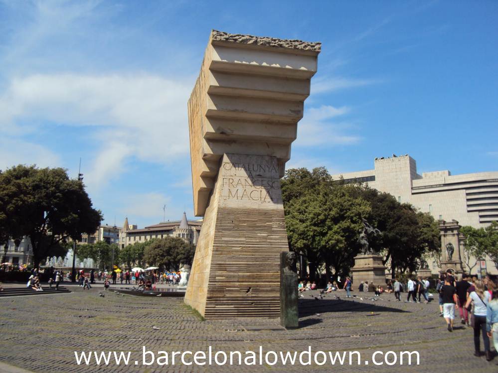 A group of tourists filing past the Francesc Masià monument in Catalonia Square Barcelona
