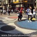 Tourists walking over Miro's famous mosaic on the Ramblas pedestrianised avenue in central Barcelona