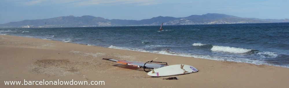 Windsurfer on the long sandy beach at Sant Pere Pescador, Spain