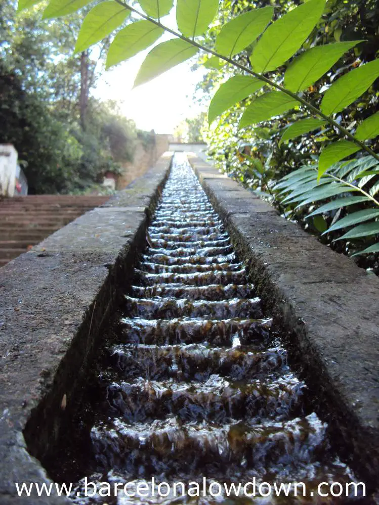 Mini waterfalls cascade down the handrail of the Generalife steps