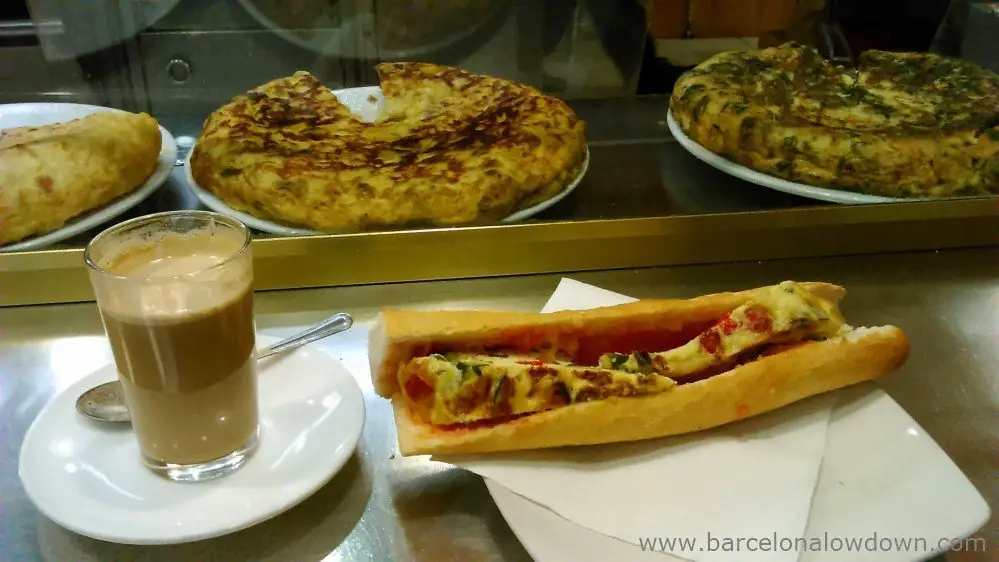 Traditional Spanish breakfast - a cup of coffe and an omlette sandwich