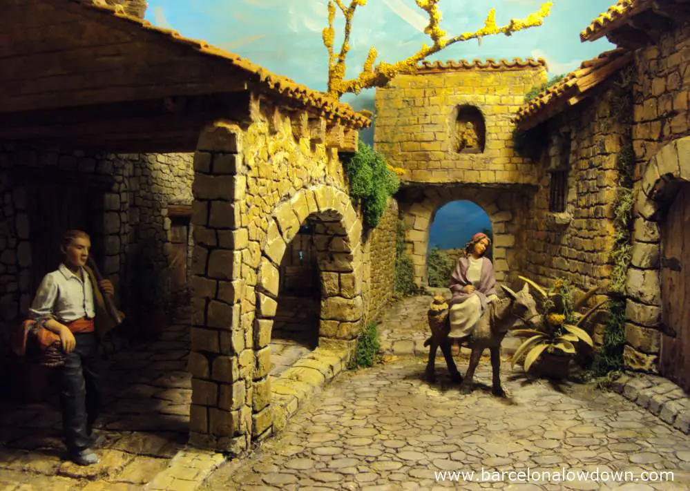 Diaorama scene depicting the virgen mary on a donkey and a peasant in traditional Catalan dress