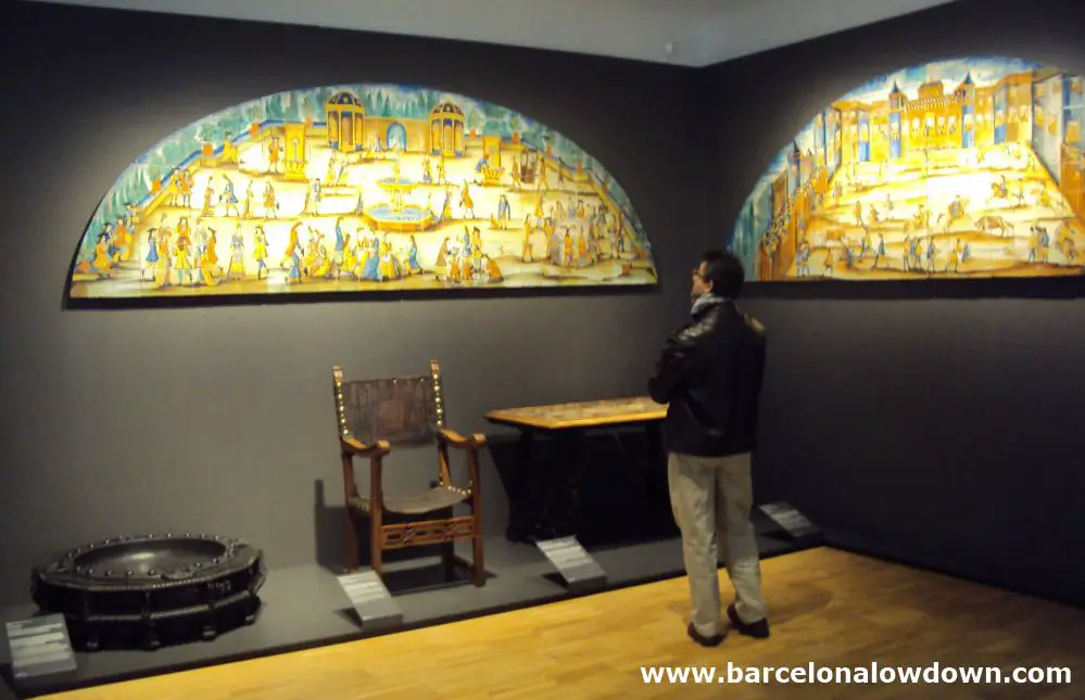 A visitor to the Barcelona Design museum looking at a set of hand painted tiles