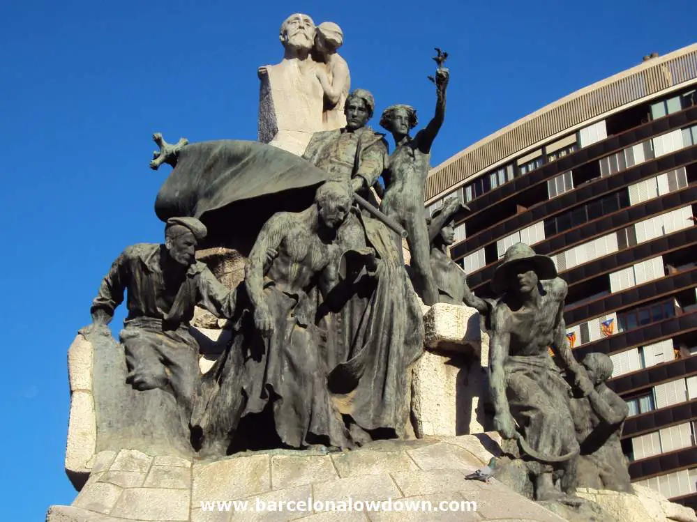 Close up of the statues topping the monument to Dr Robert. There are several bronze statues of Catalan workers and a bust of Dr Robert being kissed by a young woman.