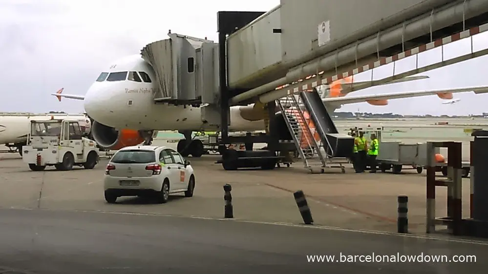An easyjet plane connected to an air bridge at Barcelona terminal T2 section C