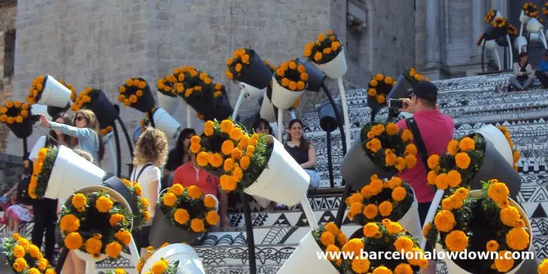 Tourists taking photos amongst the flowers at Geronas famous flower festival in Northern Spain