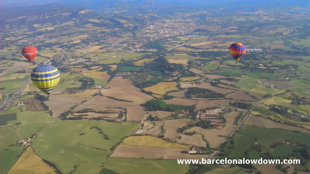 3 hot air balloons and a patchwork of fields near the Catalan Costa Brava