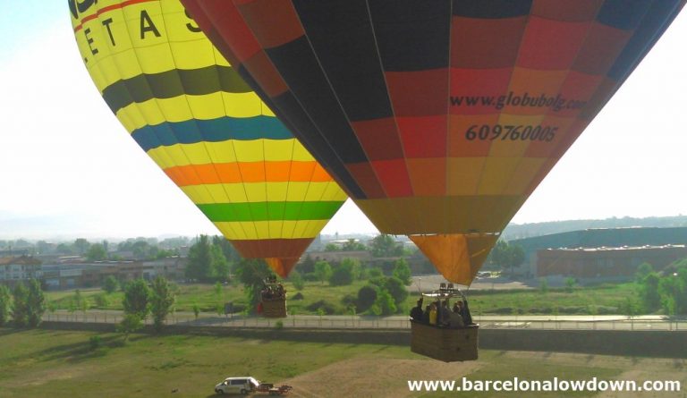 2 colourful hot air balloons take to the skies near Barcelona, Catalonia, Spain