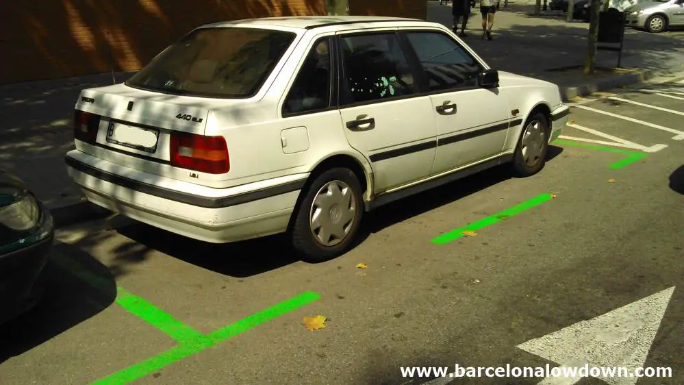 A Car parked in the green zone which becomes free parking in Barcelona during August