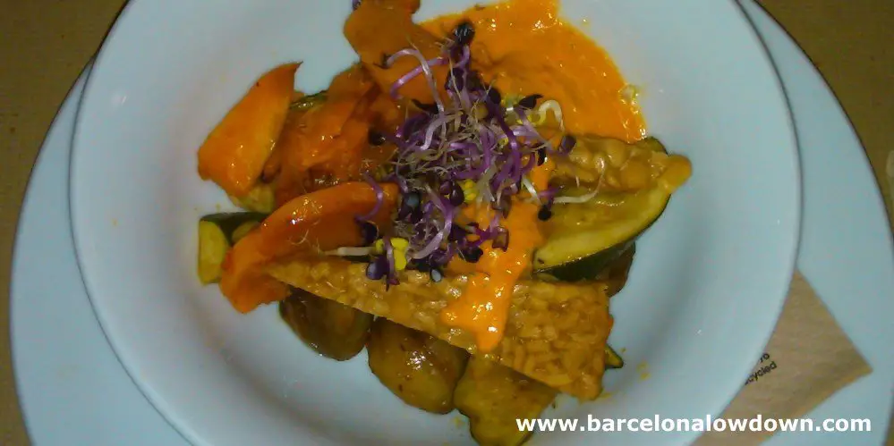 A delicious plate of tempeh with chestnuts and vegetables in one of the best vegetarian restaurants in Barcelona Spain