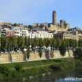 Photo of the Catalan city of Lleida taken from one of the bridges which span the River Segre. The city is dominated by the impressive medieval Seu Vella cathedral and castle which dominate the city.