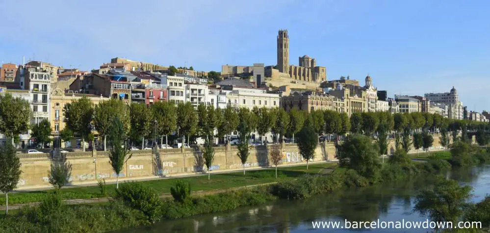 Photo of the Catalan city of Lleida taken from one of the bridges which span the River Segre. The city is dominated by the impressive medieval Seu Vella cathedral and castle which dominate the city.