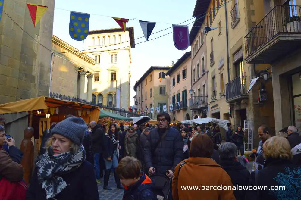 Busy streets full of people and stall selling traditional mediaval products, Vic near Barcelona