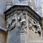 Stone carving of Wilfred the Hairy slaying a dragon with a wooden staff nect to the door of Barcelona cathedral