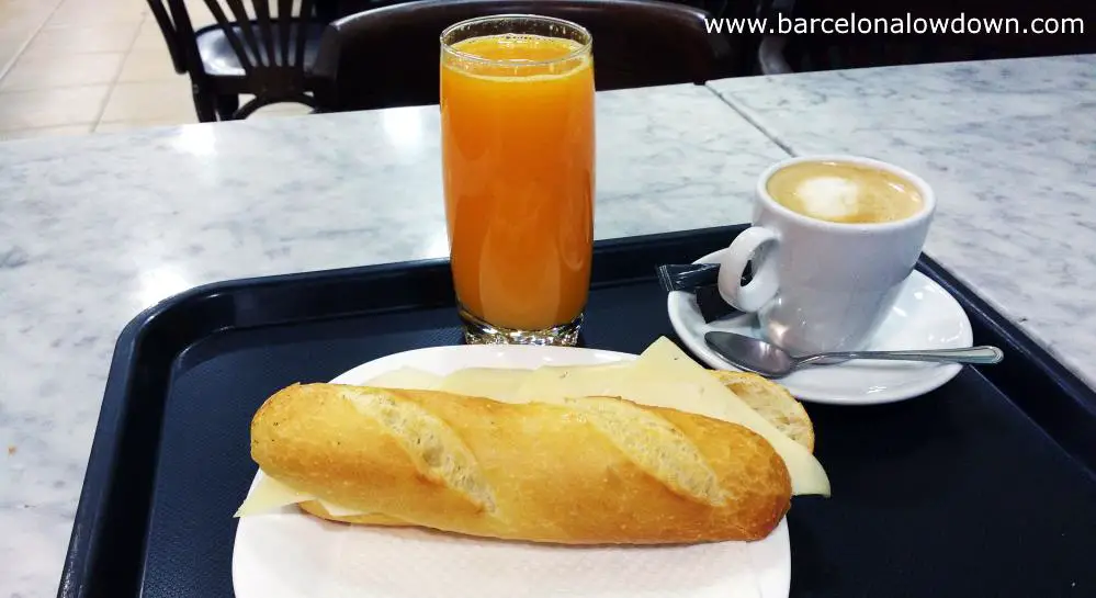 A typical Spanish breakfast in Barcelona consists of a sandwich, orange juice and coffee