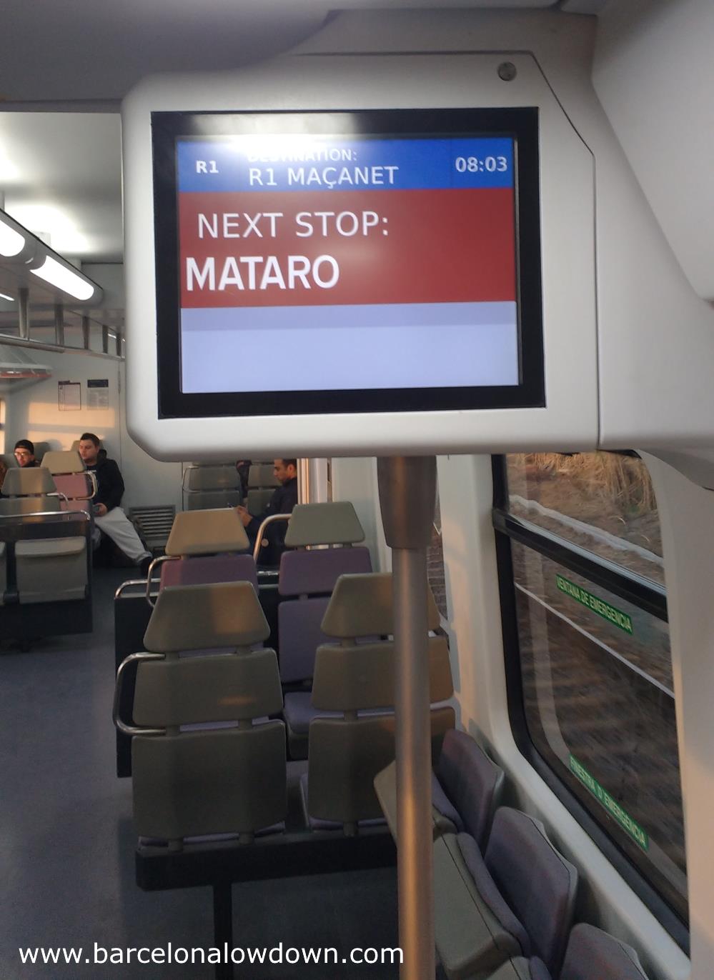 Interior of a Barcelona commuter train showing the information screens