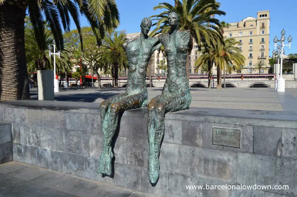 Bronze statue of a loving couple located near Barcelona's historic port and seafront area