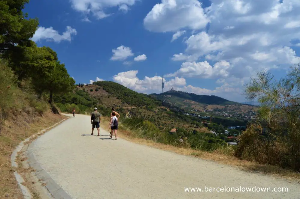 A group of friends walking the Carretera de les aigues walking trail in Collserola national park Barcelona