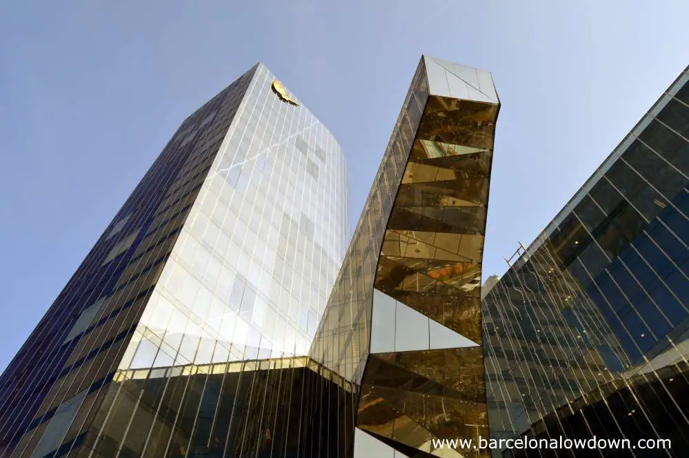 The abstract styled glass Torre Mare Nostrum sckscraper in Barcelona seen from below