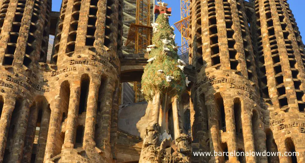 Close up of the bell towers of the nativity façade of the Sagrada Familia Basilica in Barcelona. Tou can see the Christmas tree with 12 doves as well as part of 4 bell towers.
