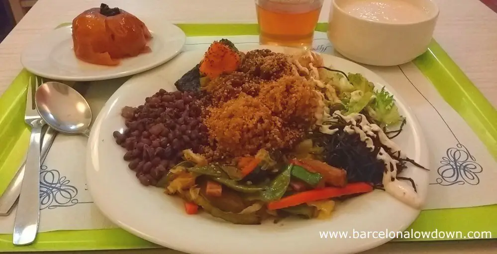 A macrobiotic lunch including lentils, seaweed, tofu, carrots, beans, salad, apples tea and soup served at the Macrobiotic Zen vegan restaurant in Barcelona