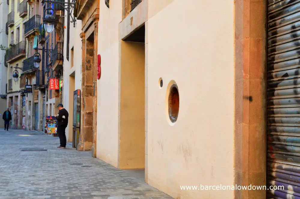 Photo of the main façade of the house of mercy orphanage including the foundling wheel or baby hatch in Plaça de Vicenc Martorell, Barcelona