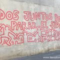Todos juntos podemos parar el SIDA (Together we can stop aids) written in blood red letters in a mural by Keith Haring in Barcelona