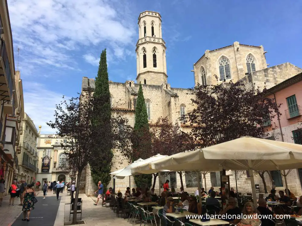 A street cafe in a square in front of the church of Sant Pere, Figueres, Catalonia Spain