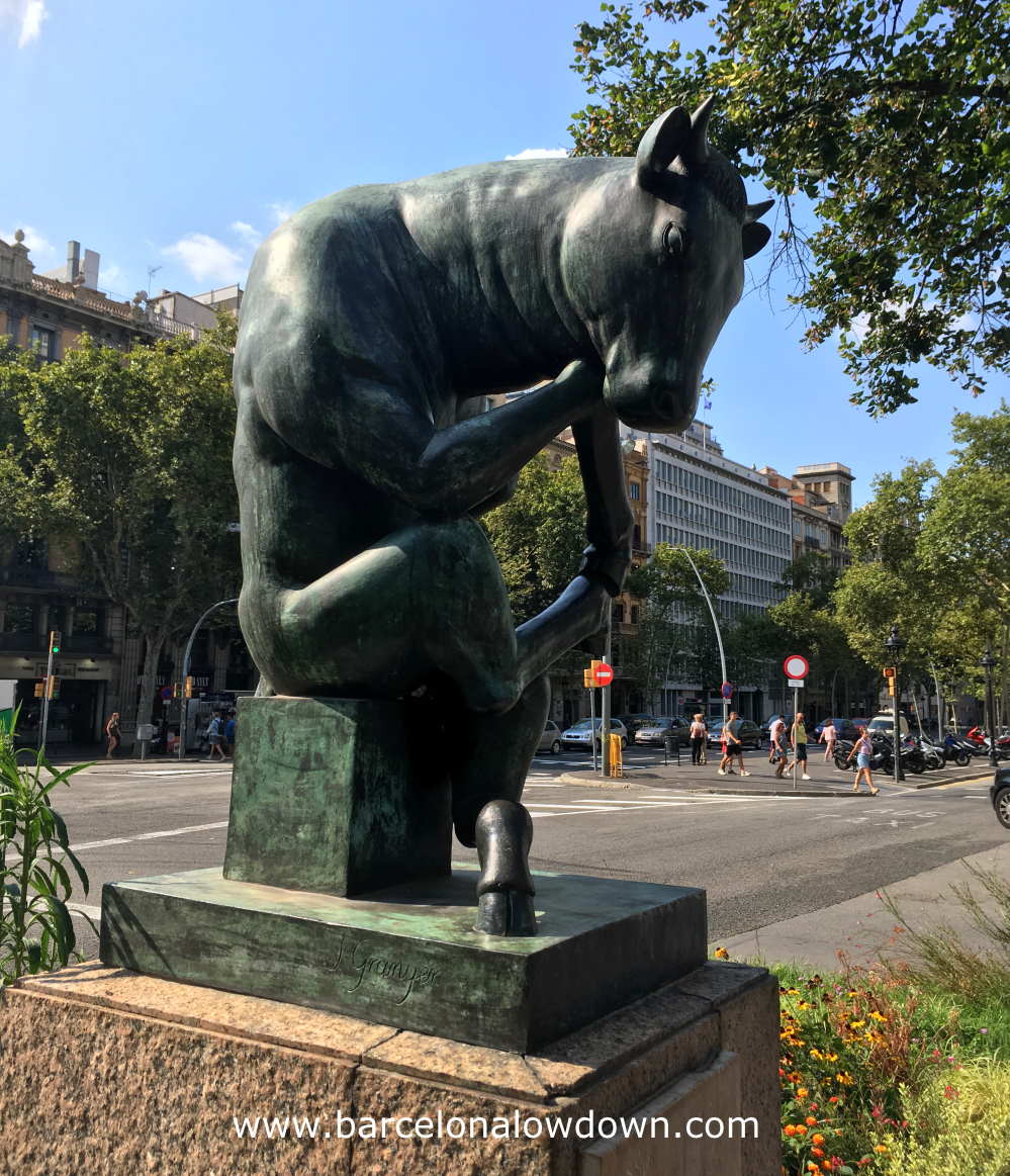 Statue of a bull in a pose based onThe Thinker statue by Rodin