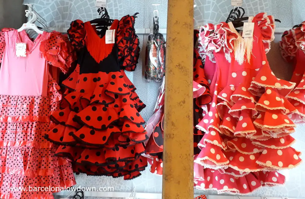 Souvenir flamenco dresses on display in a shop at Barcelona airport