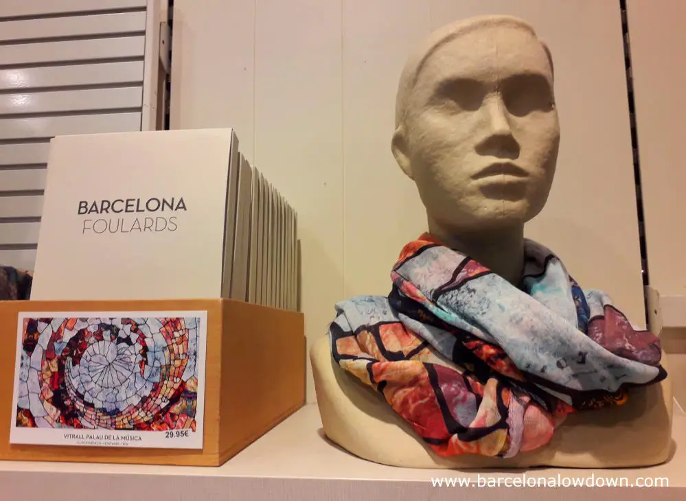 A shops dummy with a colourful ladies scarf inspired by the Catalan musica palace