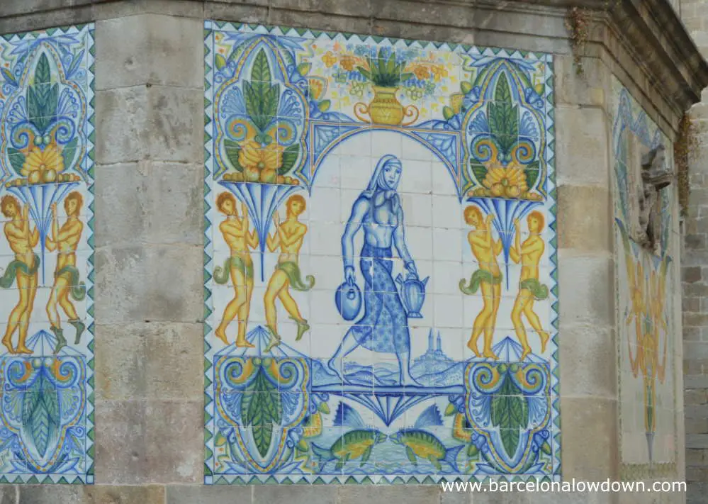 Mosaic of a woman carrying water on the side of St Annes Fountain Barcelona