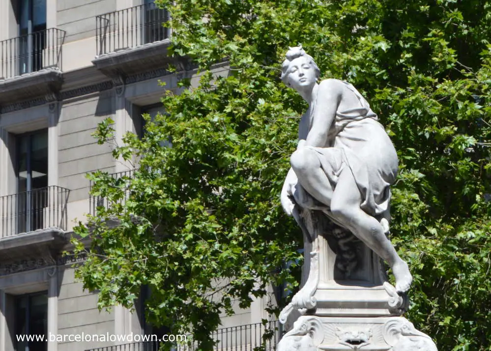 Close up photo of Diana the Huntress in front of leafy trees on Gran Via Barcelona