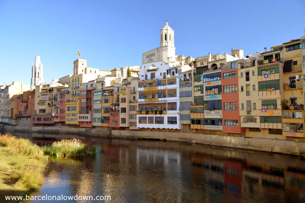 View of Girona from one of the bridges over the Onyar river, you can see the cathedral and the famous colorful houses