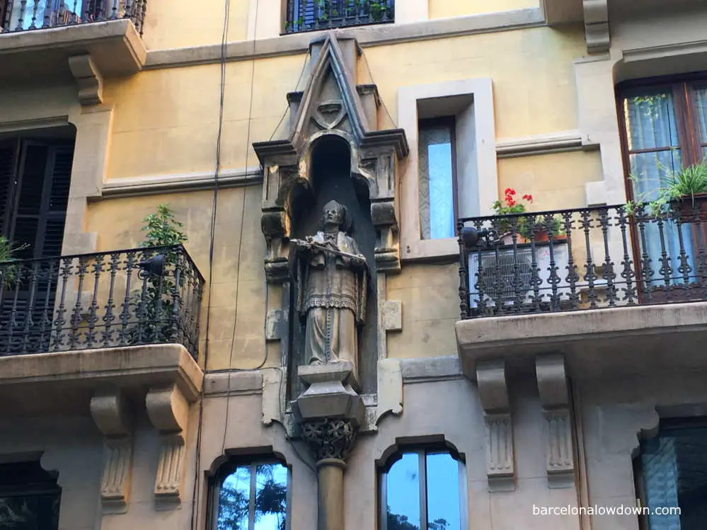 Statue of Saint Josep Oriol on the façade of a building, Barcelona